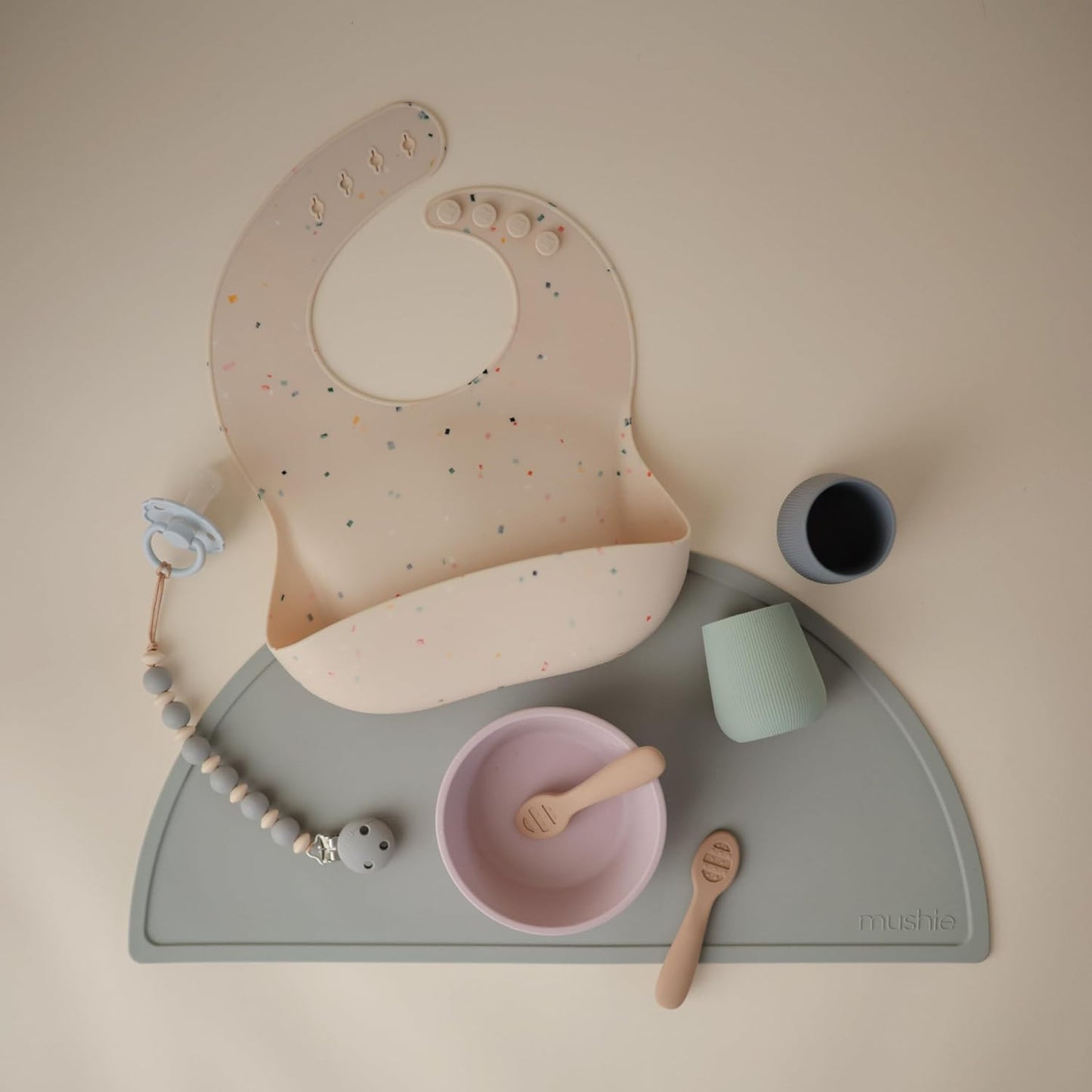 mushie Silicone Baby Bib | Adjustable Fit Waterproof Bibs (Vanilla Confetti)